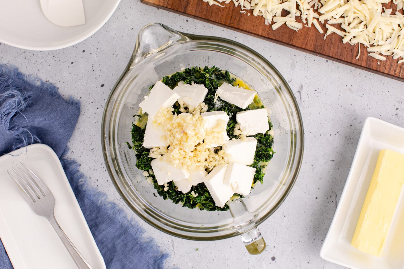cubed cream cheese, garlic, and pepperjack cheese added to eggs and spinach