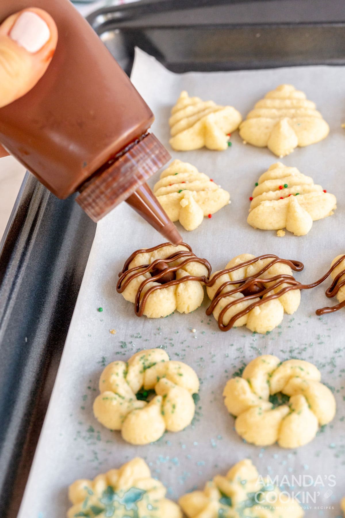 drizzling chocolate on cookies