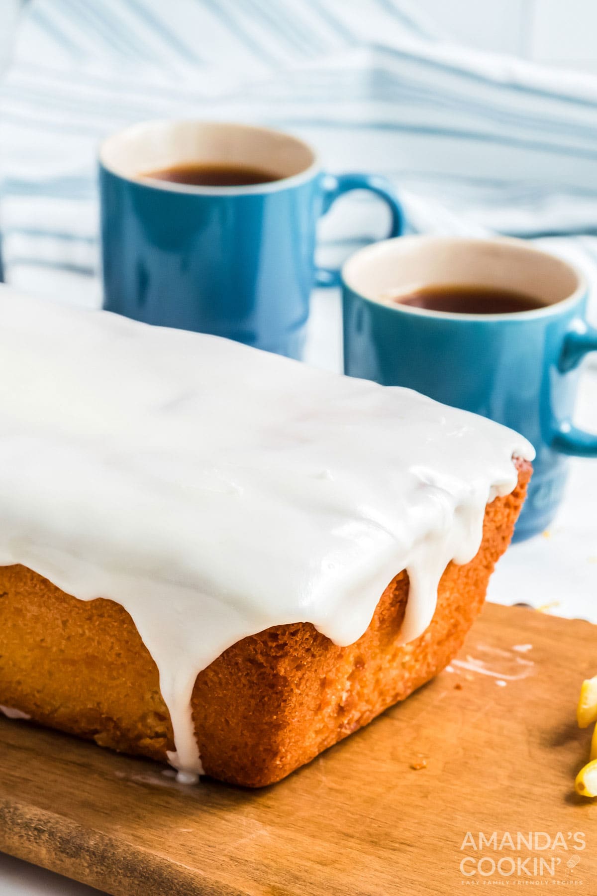 glazed quick bread with coffee cups in background
