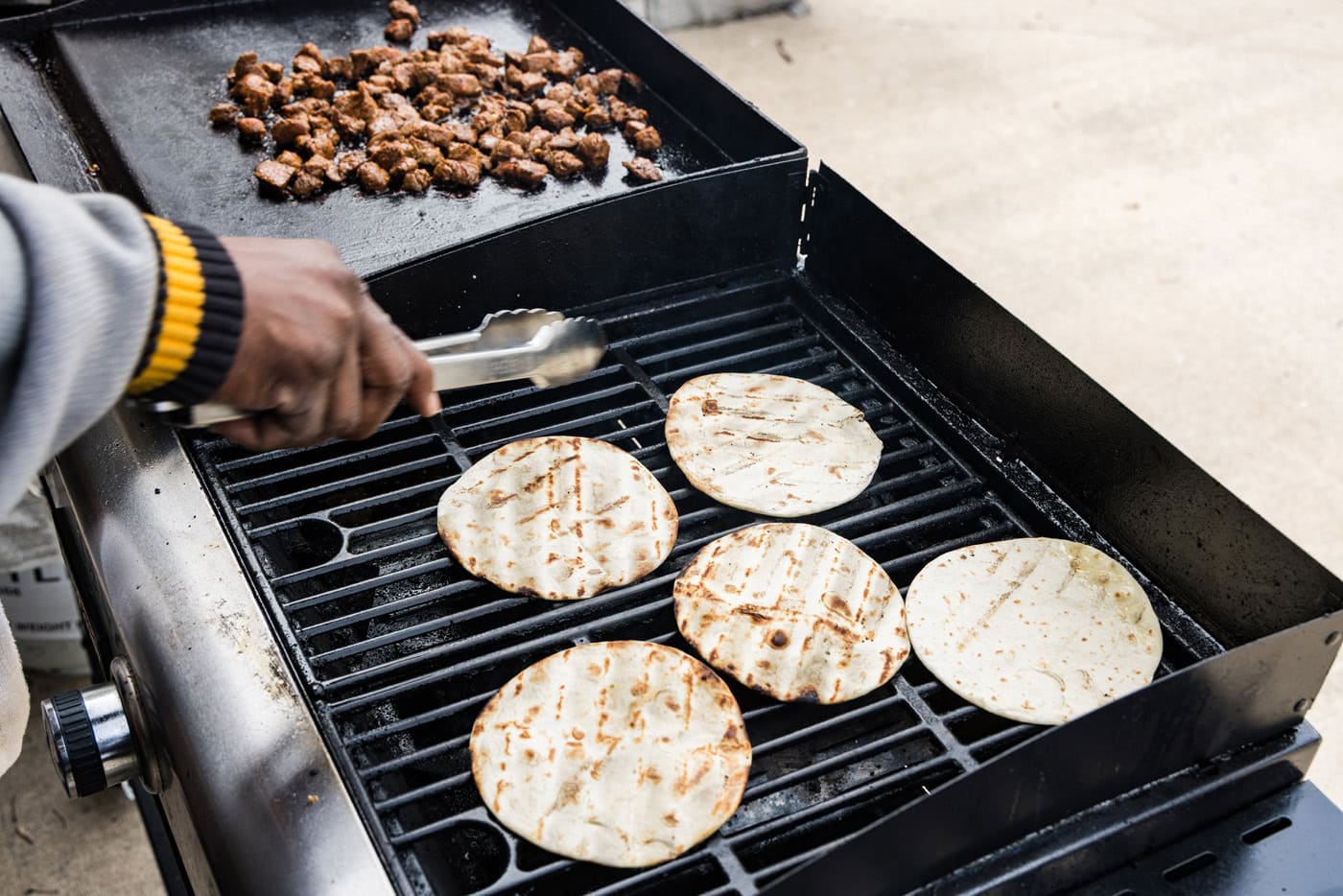 flipping taco shells on grill