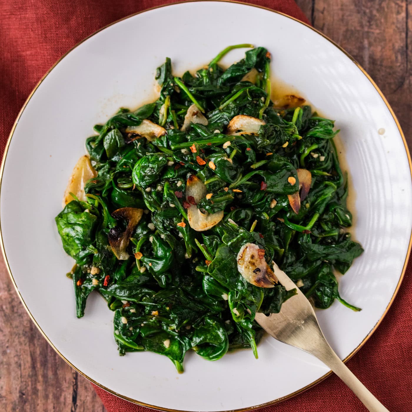 Plate of Stir Fried Spinach with a fork resting to the side
