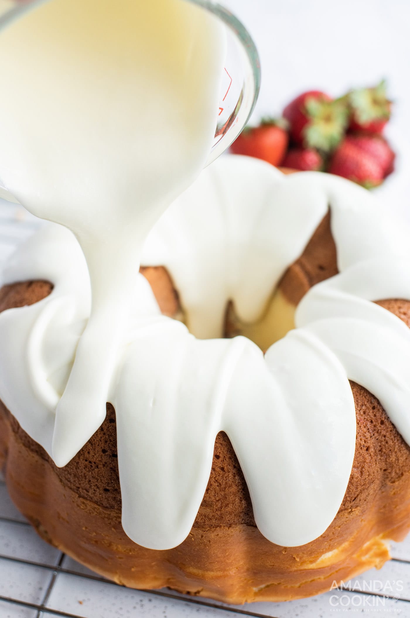 pouring icing on cake