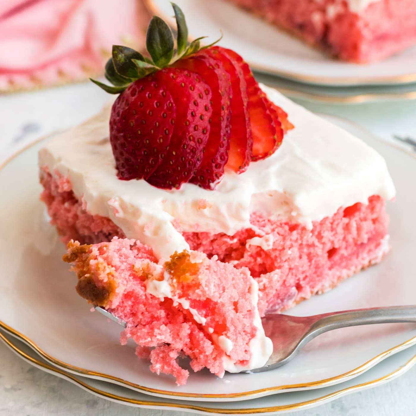 slice of strawberry cake with a fork