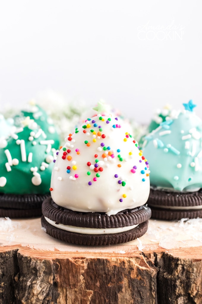 chocolate covered strawberry christmas trees on a wood platter