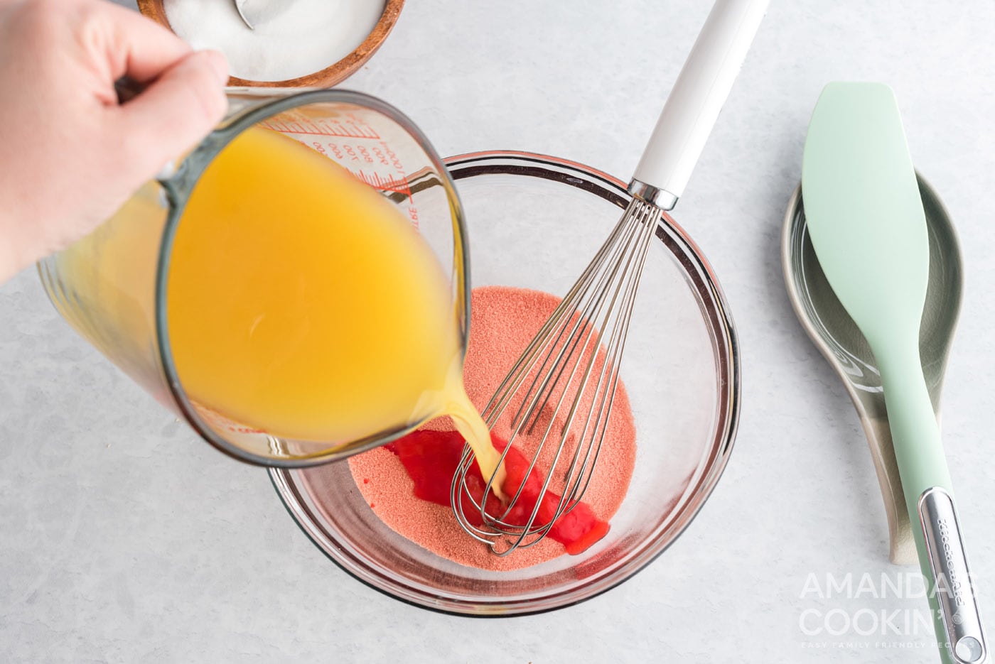 pouring pineapple juice into strawberry gelatin