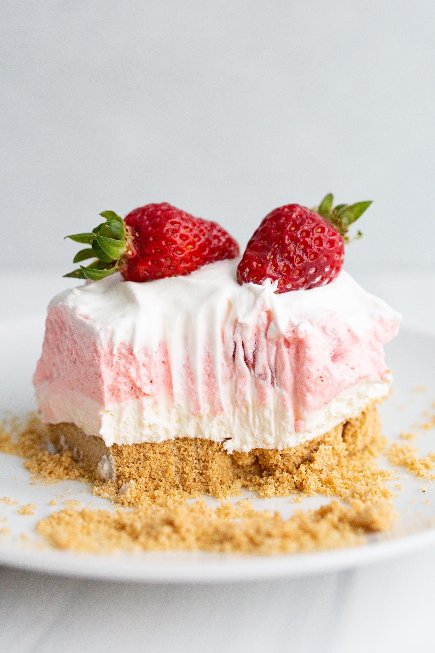 Square of Strawberry Lasagna on a plate with a bite taken out