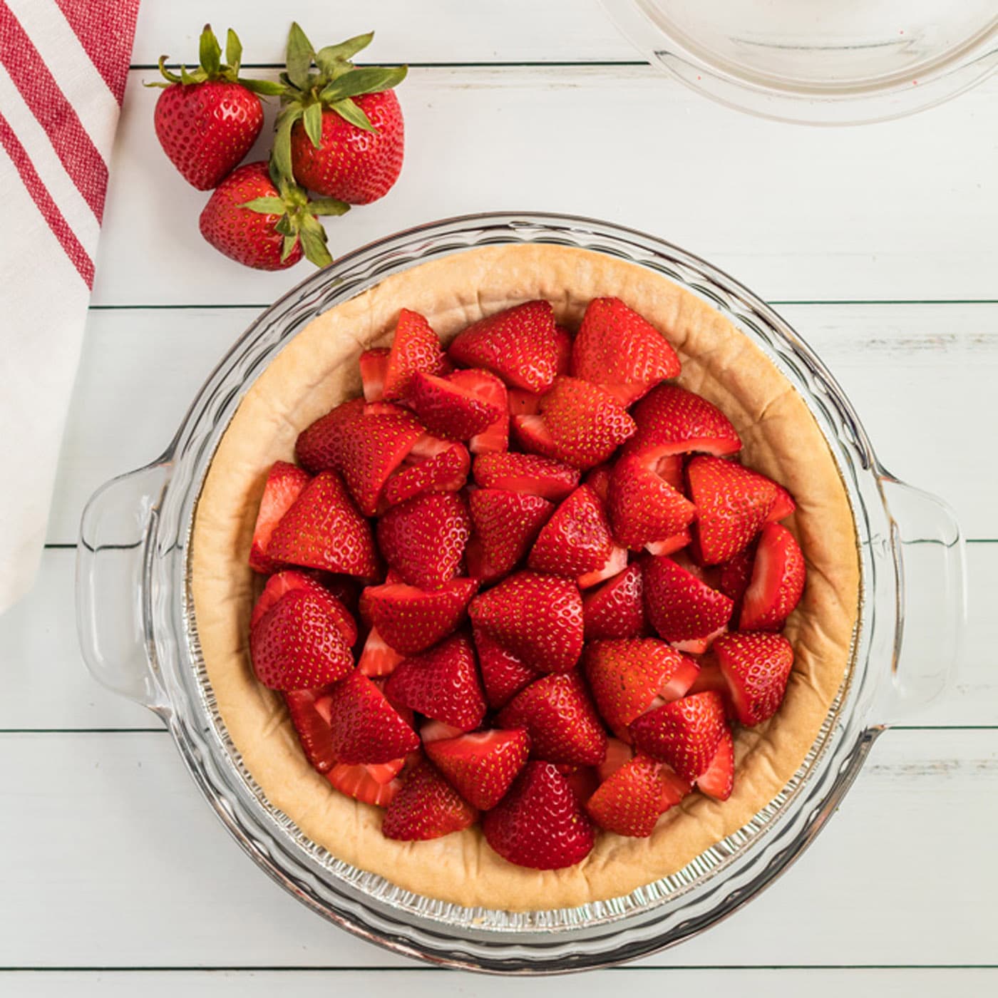 Sliced strawberries in a baked a cooled crust