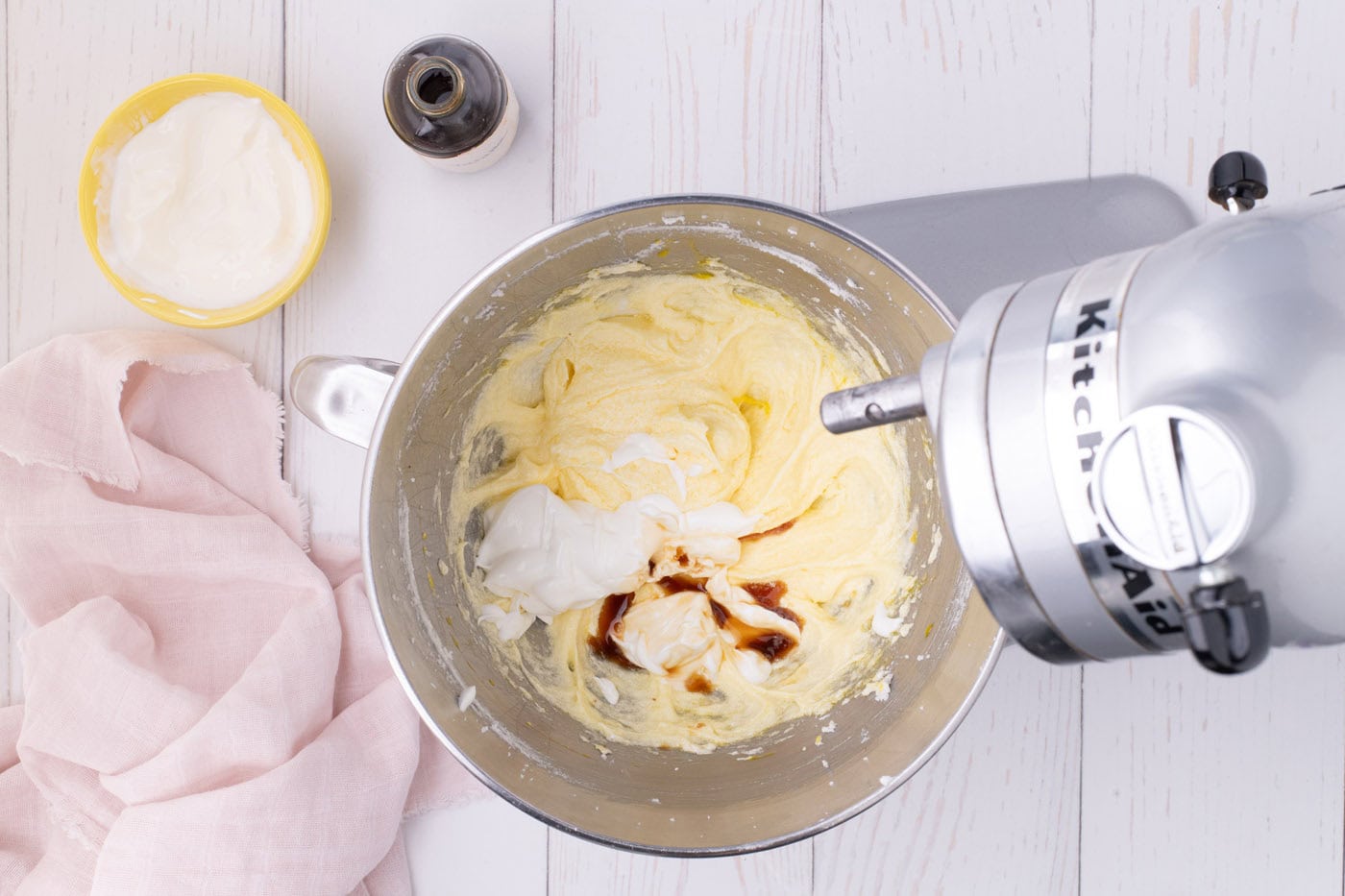 adding vanilla and sour cream added to creamed butter and sugar mixture in a stand mixer
