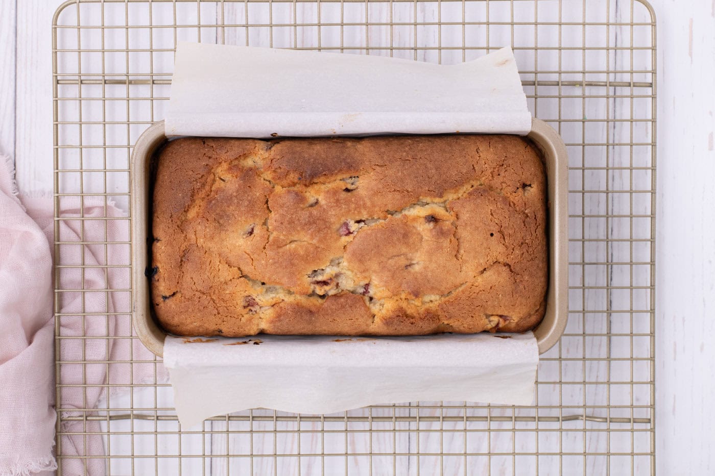 baked strawberry pound cake overhead on a cooling rack