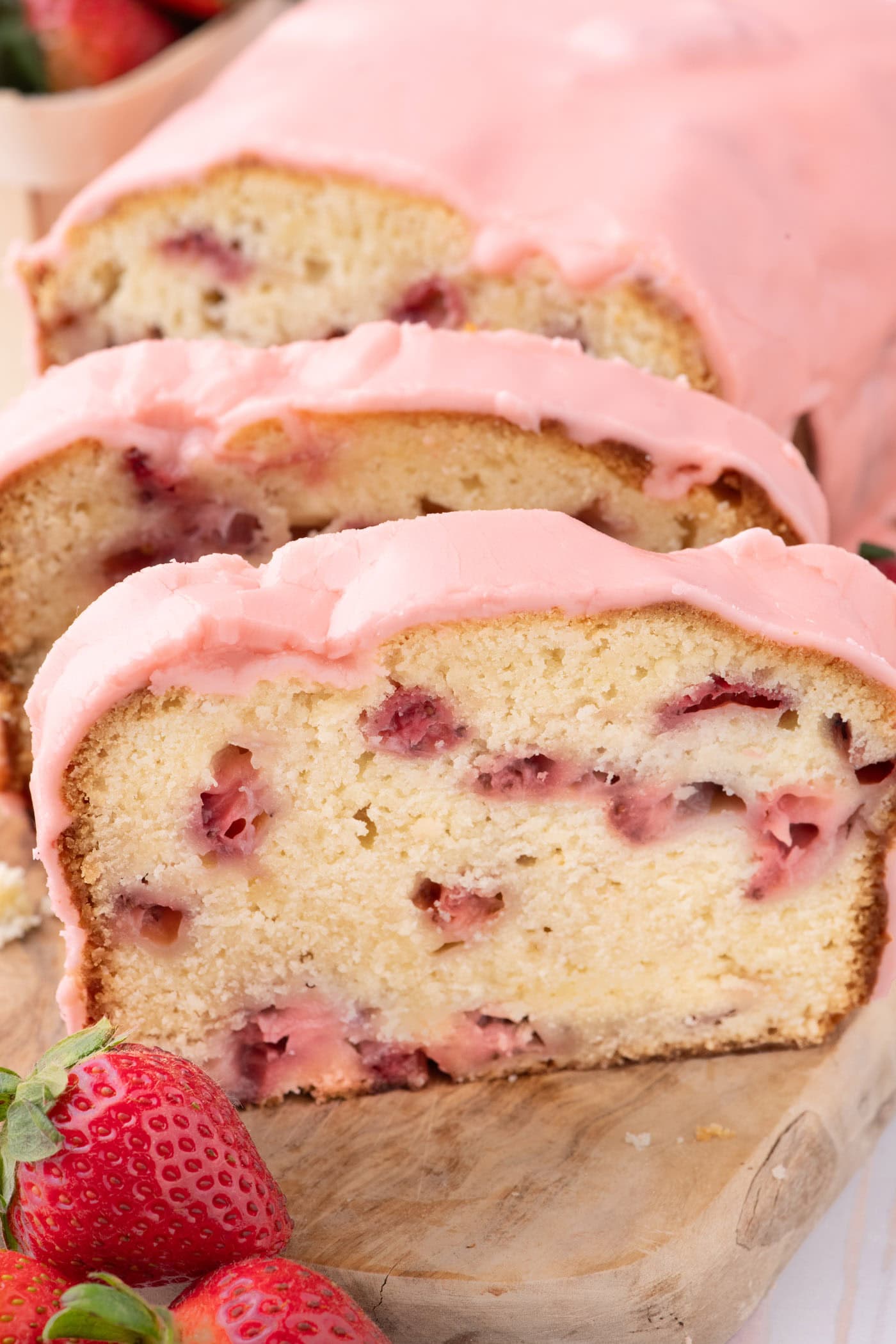 Slices of Strawberry Pound Cake on a wooden board