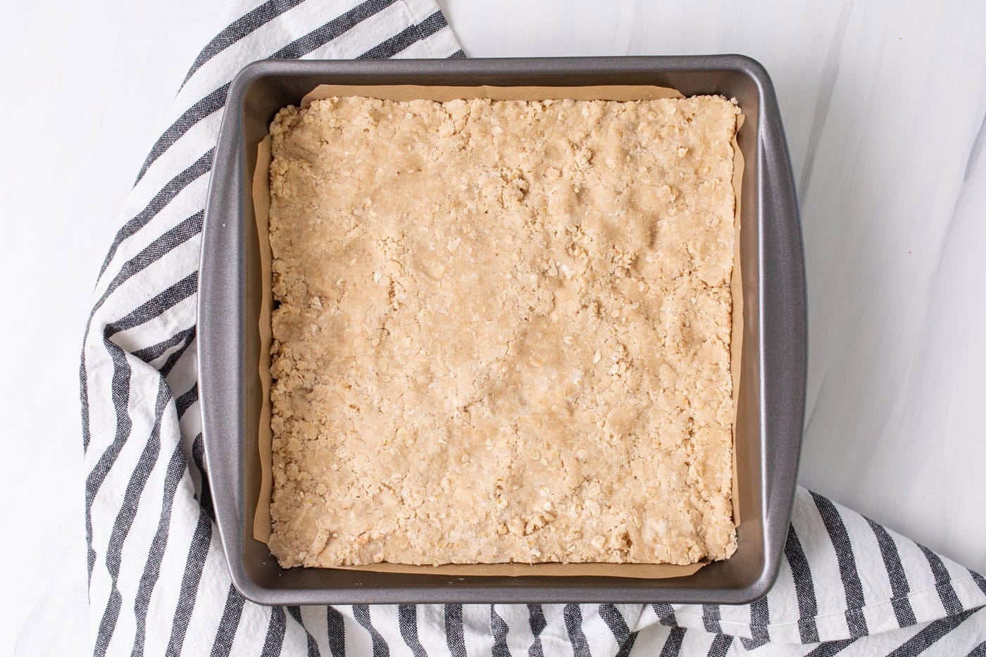 rhubarb crumble bars crust in a pan