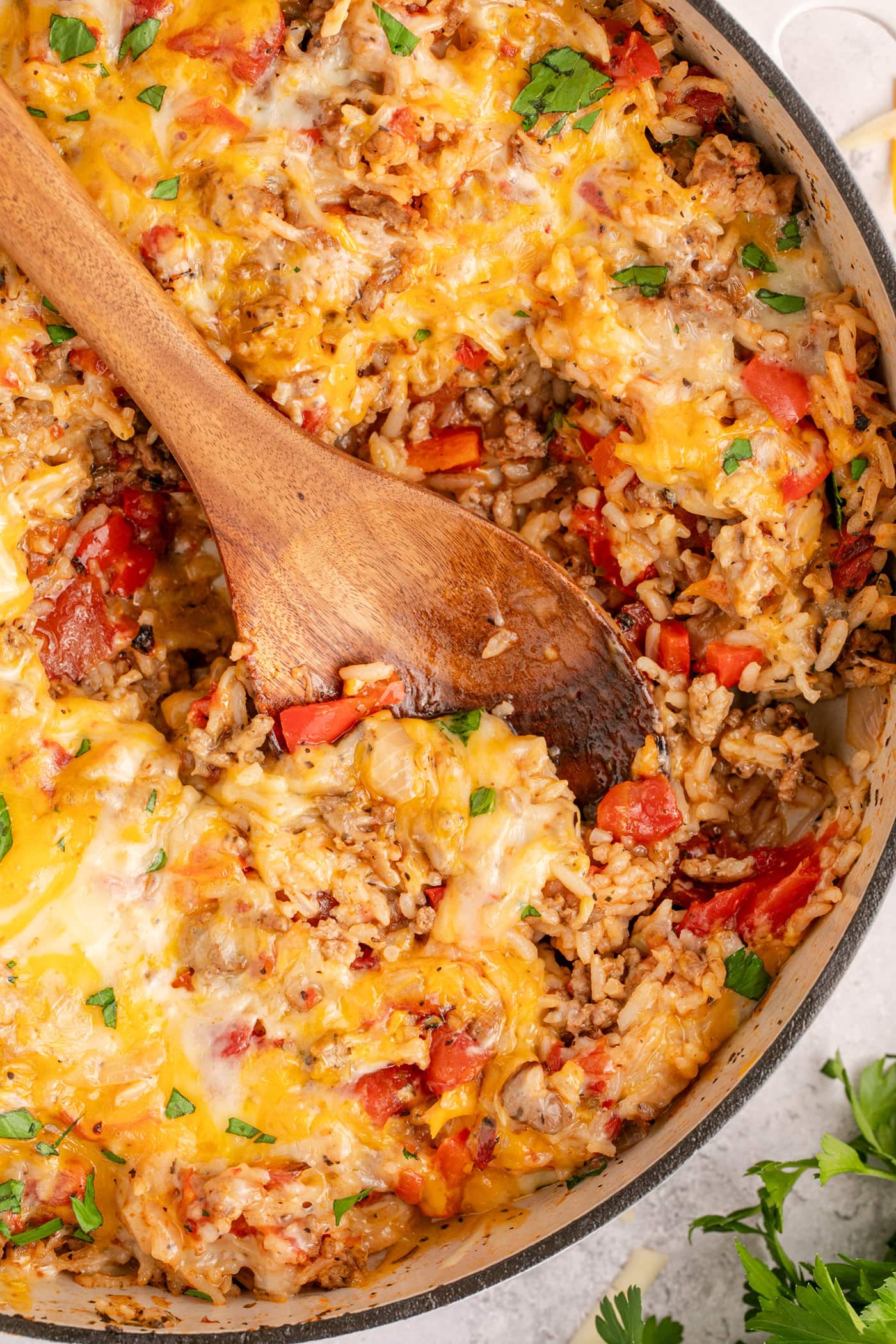 Spoon resting in a dutch oven filled with Stuffed Pepper Casserole