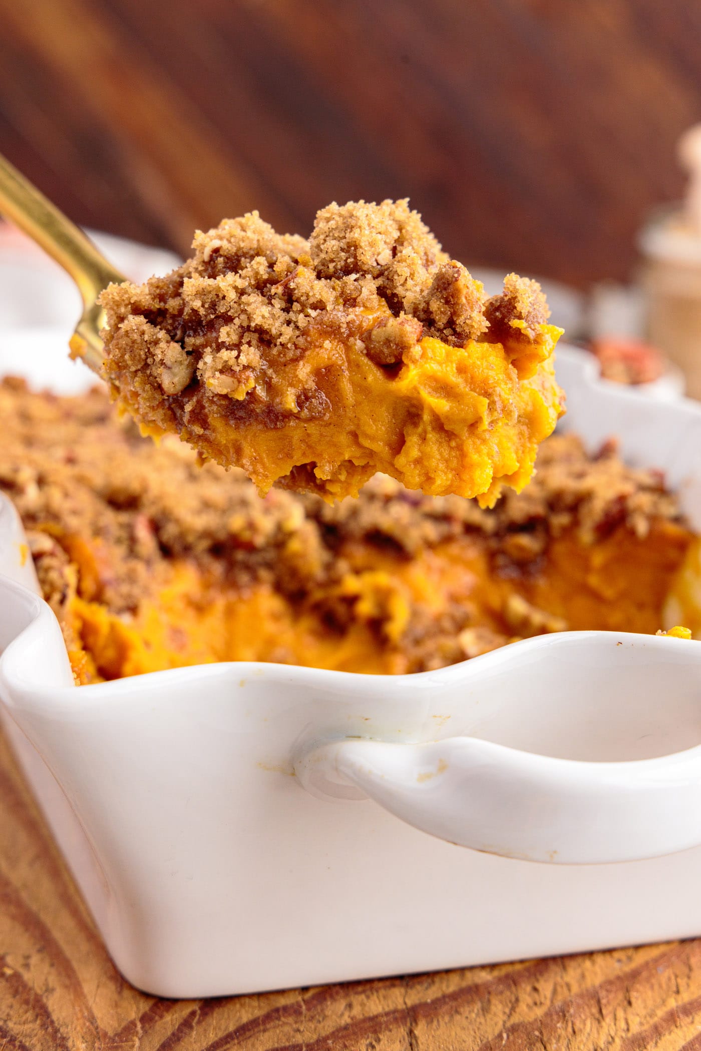 Spoonful of Sweet Potato Souffle being lifted out of the baking dish