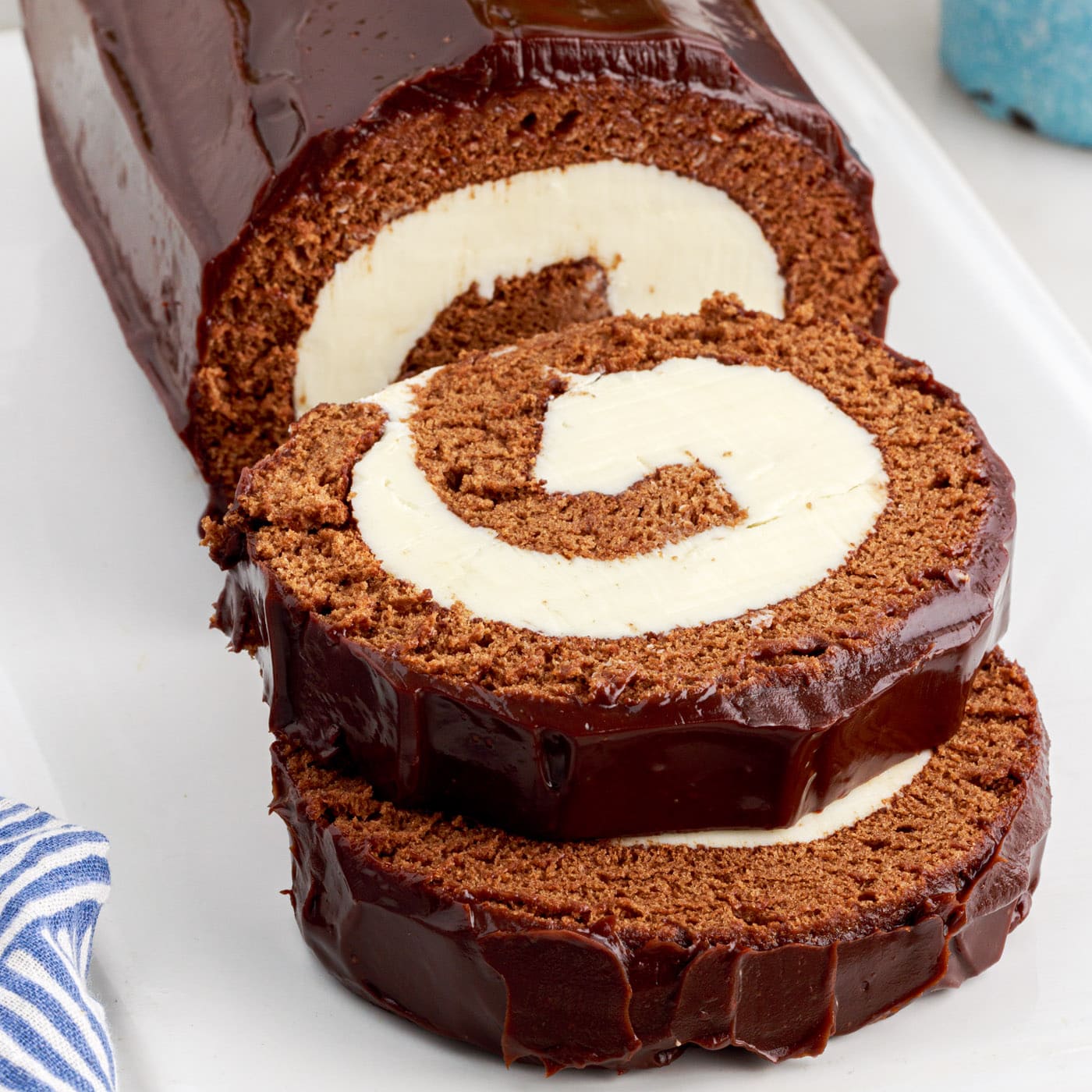 Close up photo of two slices of Swiss Roll stacked on top eachother