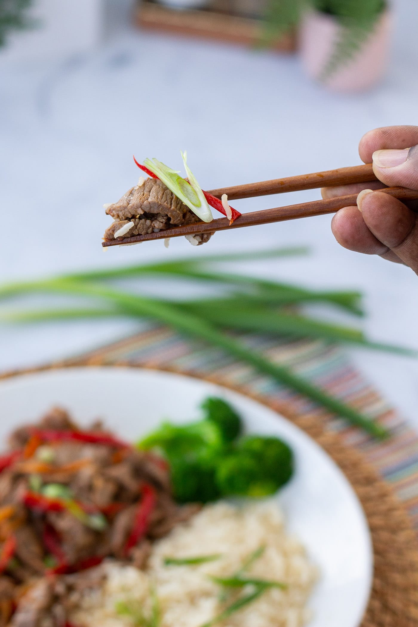 picking up Szechuan Beef with chopsticks