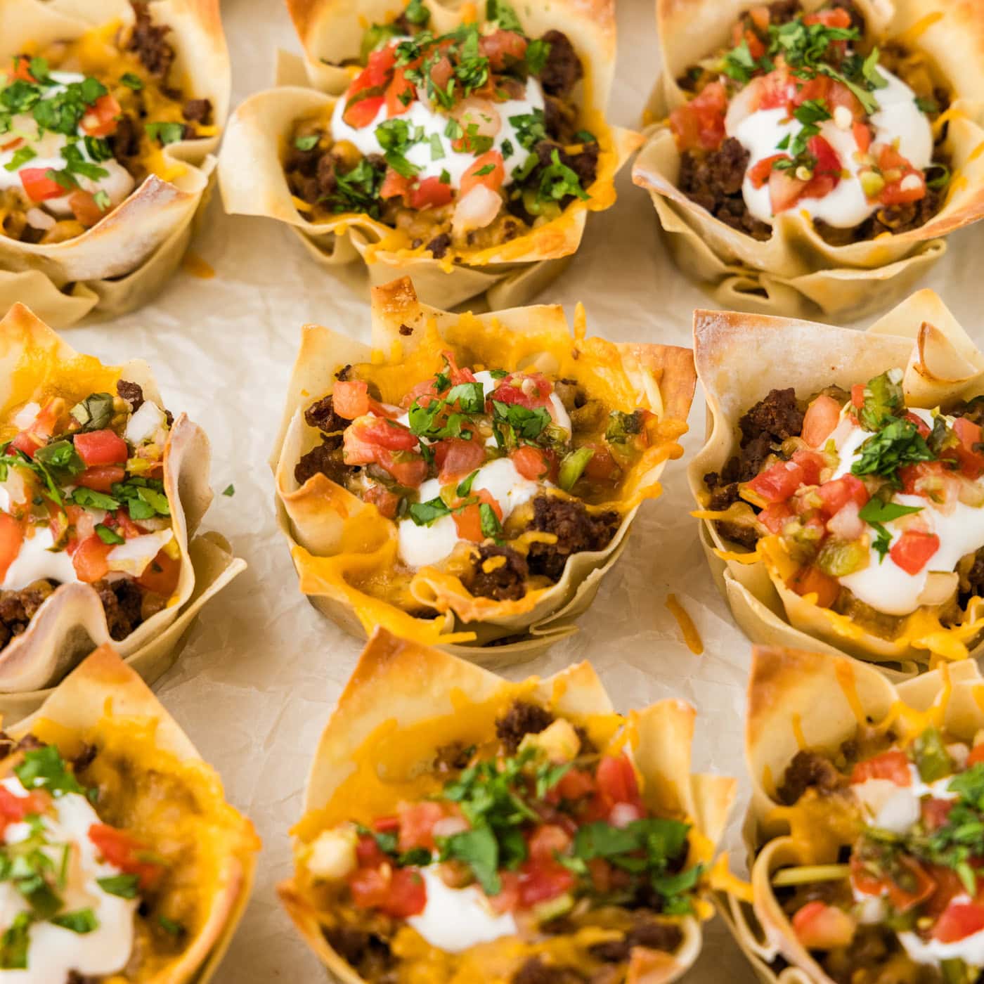 Close up photo of Taco Cups resting on parchment paper