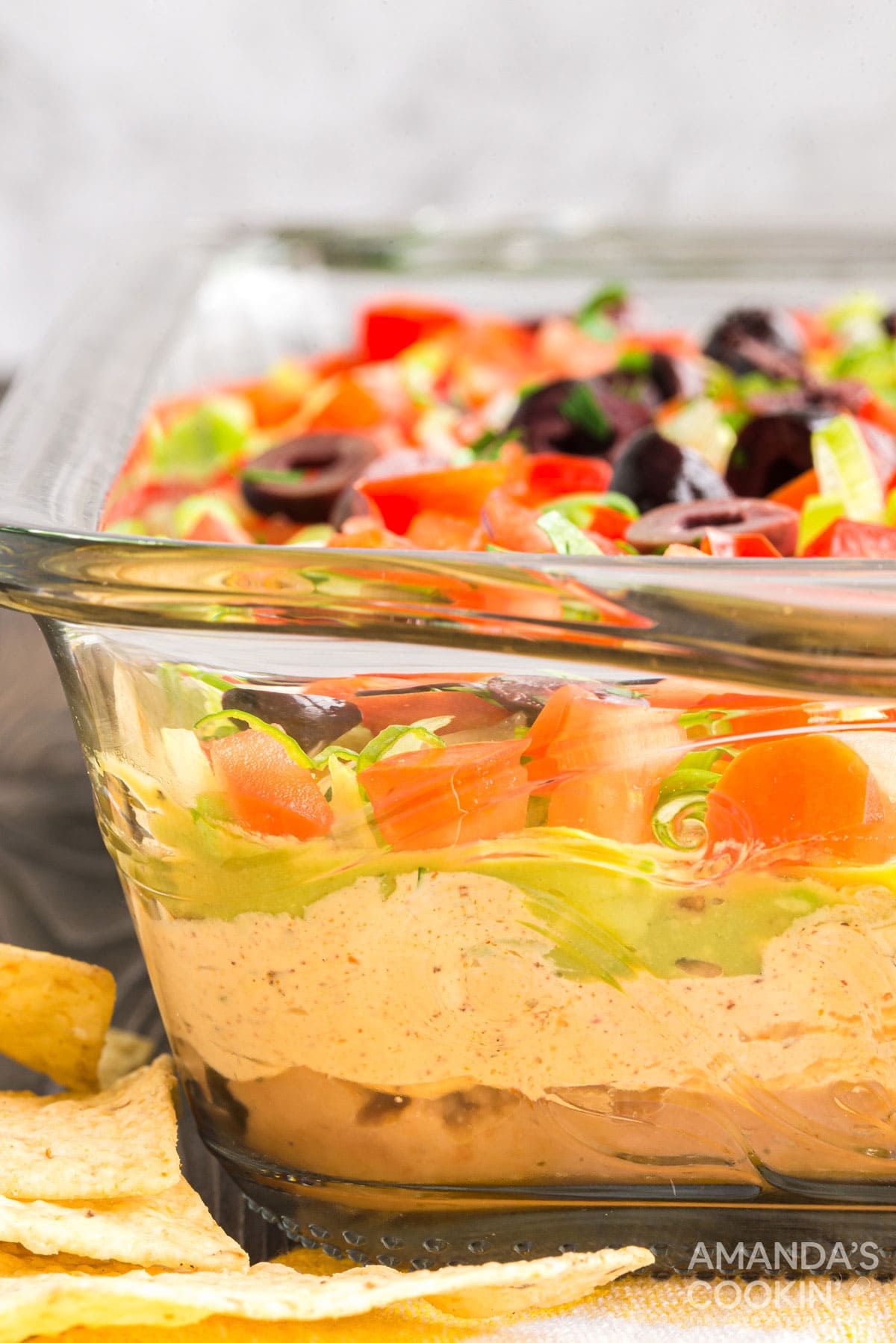 side view of glass pan with taco dip showing layers