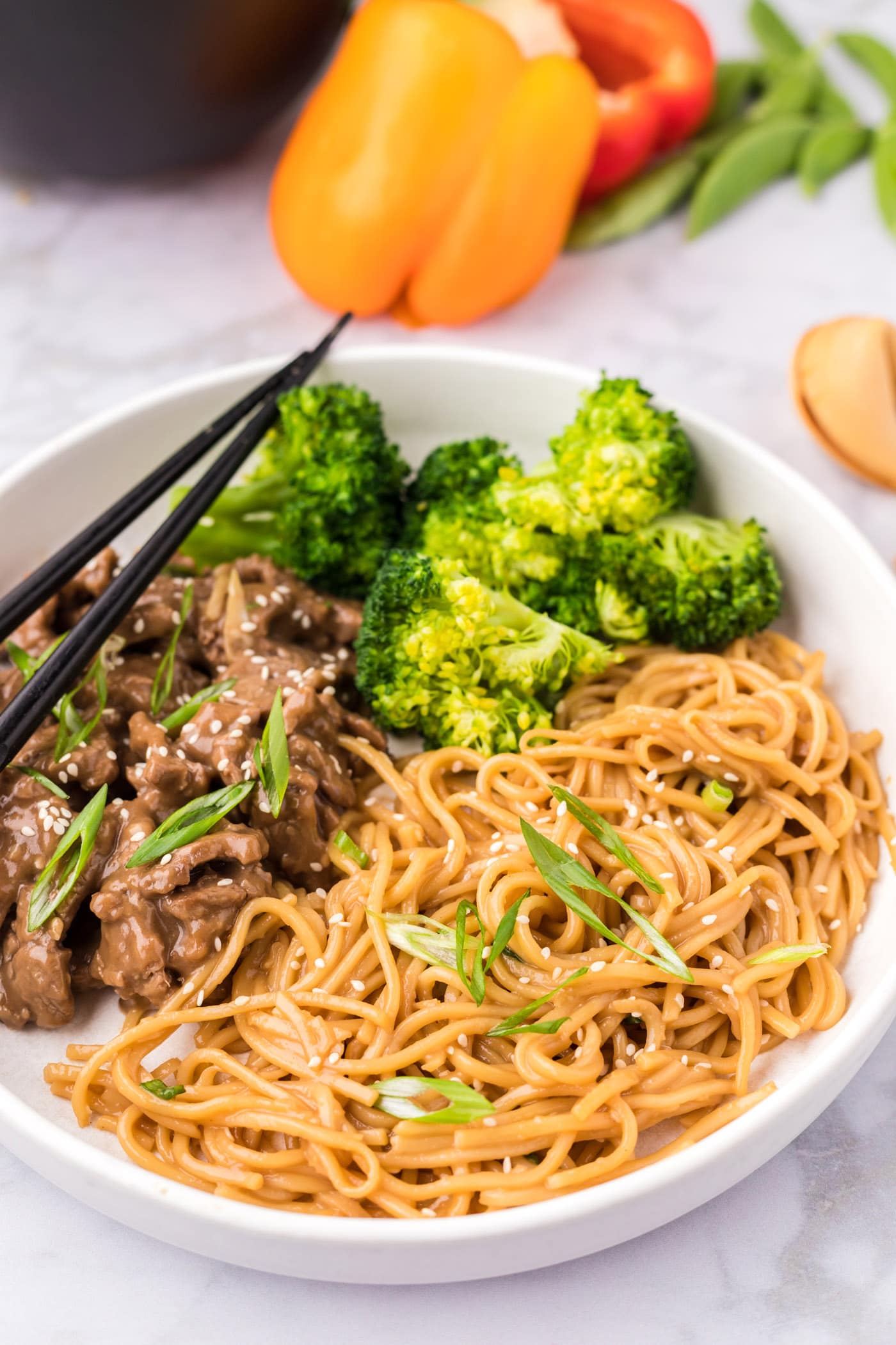 Teriyaki Noodles plated with broccoli and beef teriyaki