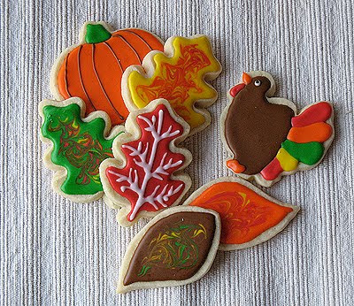 A photo of an assortment of thanksgiving cookies.