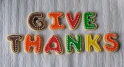 A close up photo of give thanks thanksgiving cookies.
