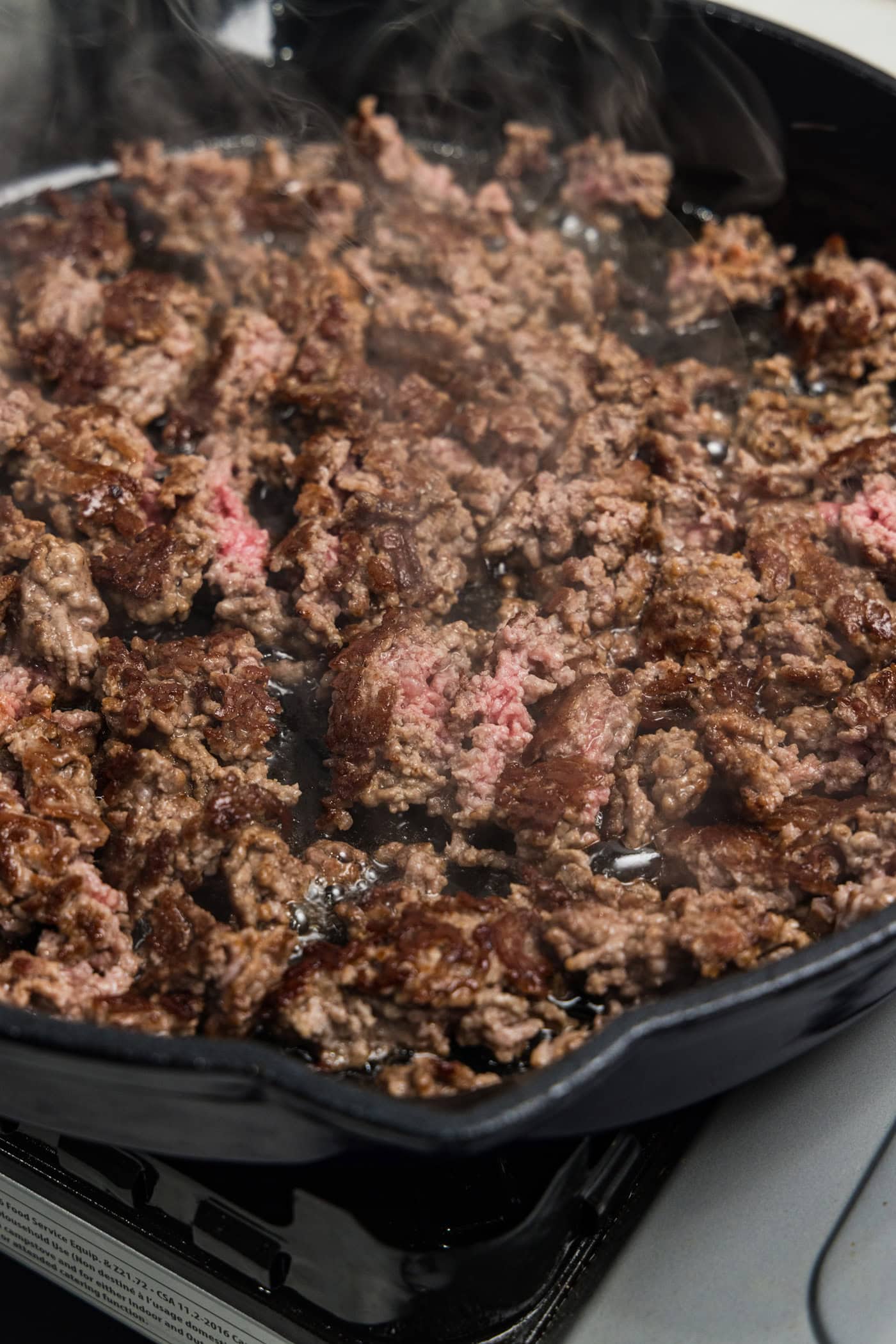 Ground beef searing in skillet