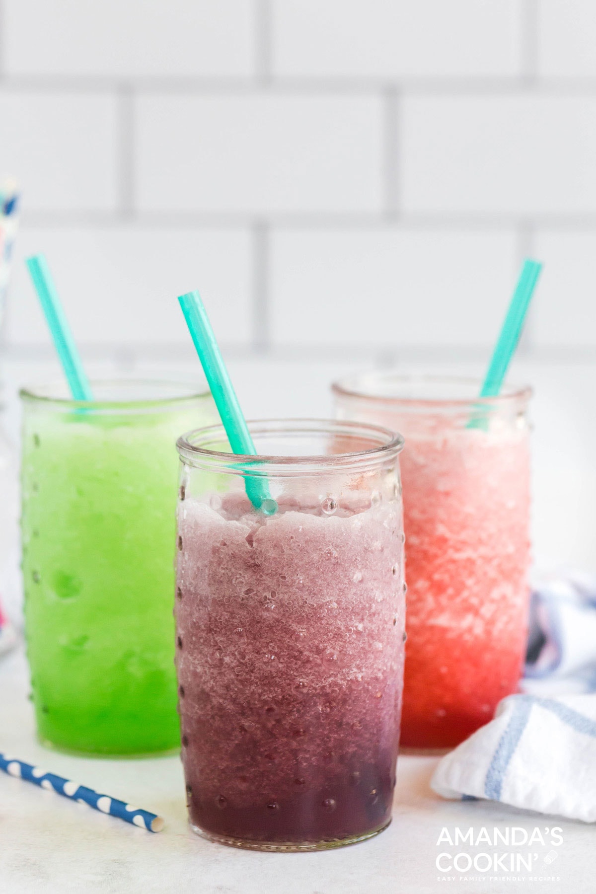 three slushies with straws