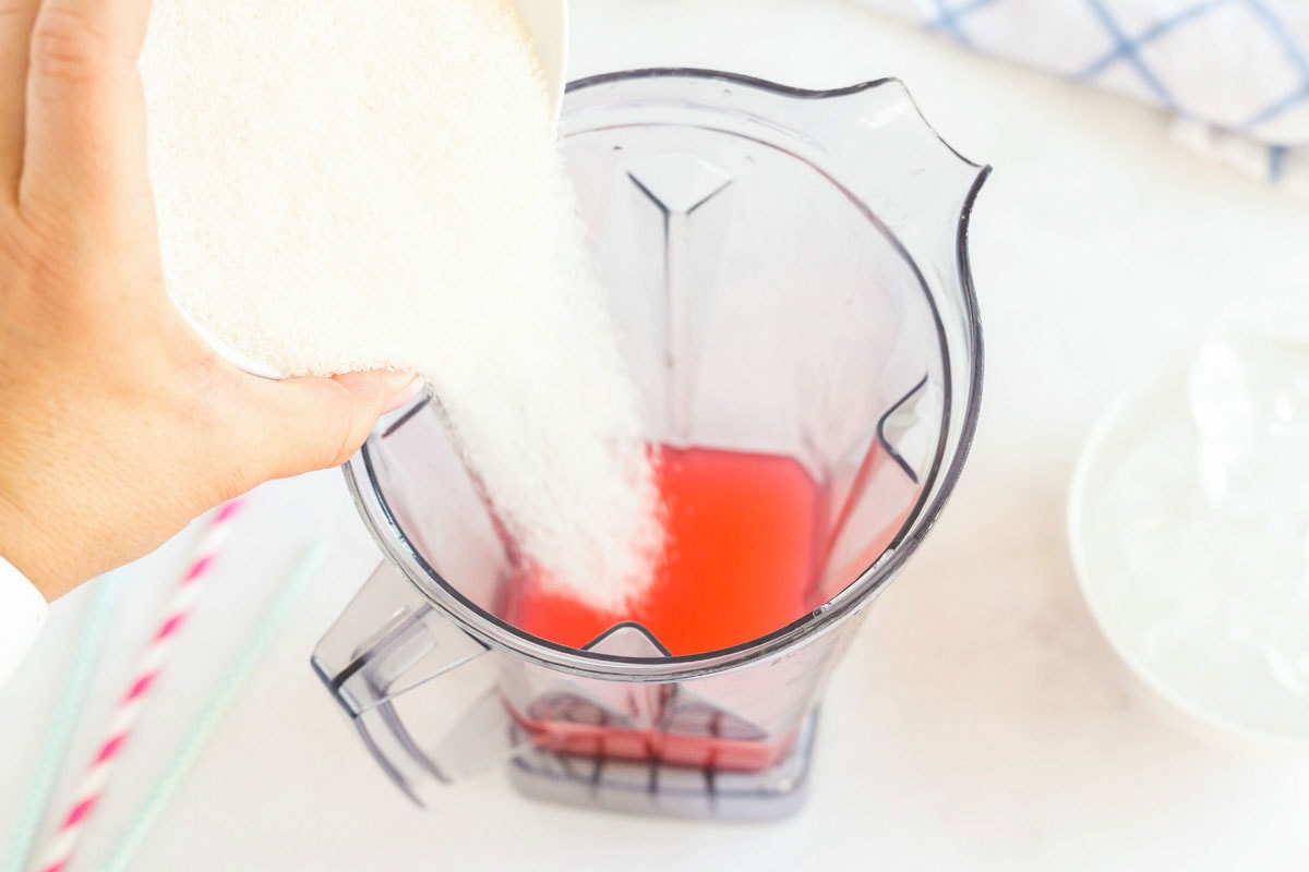 adding sugar to blender