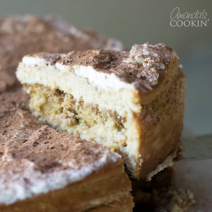 removing a slice of tiramisu cheesecake