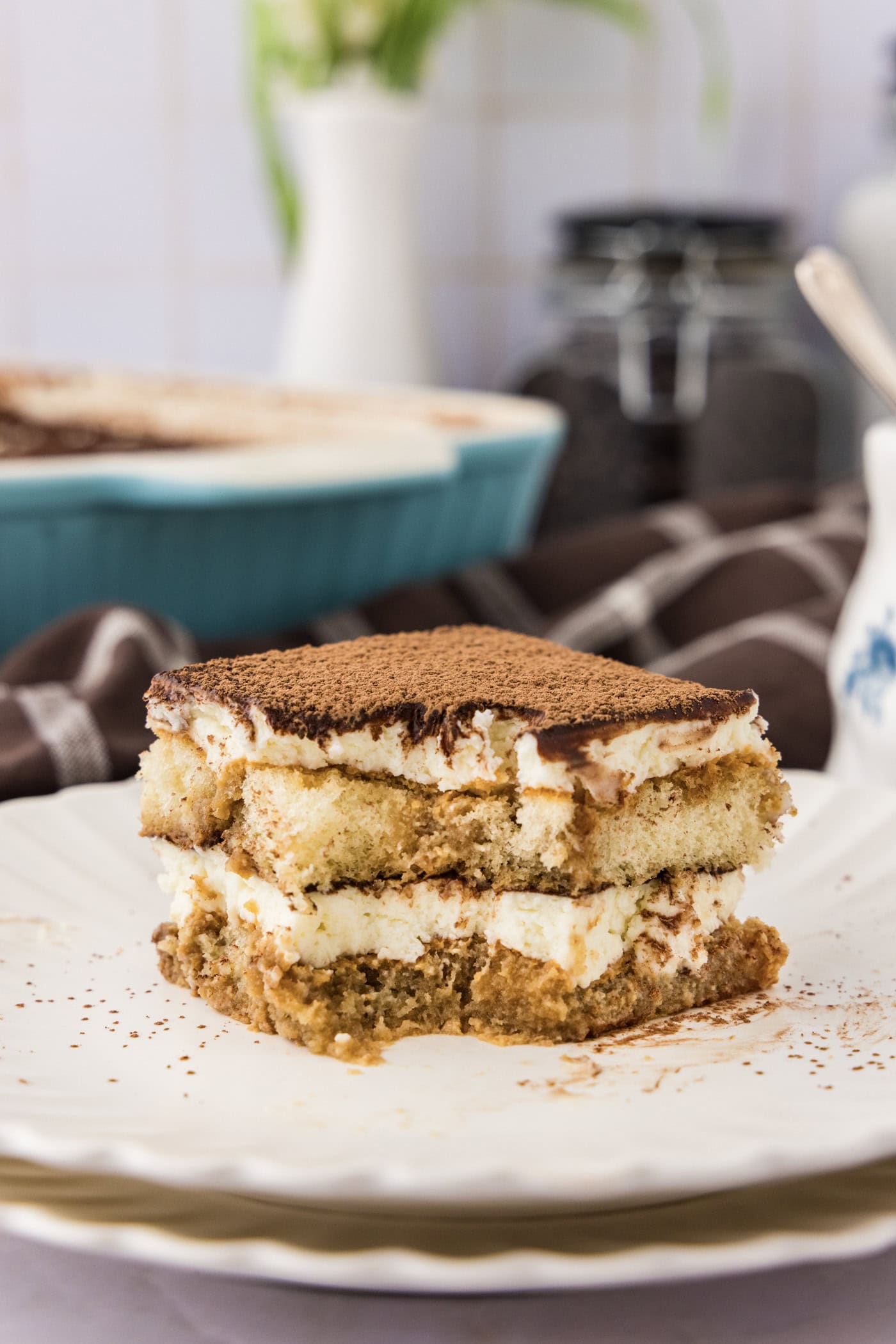 Slice of Tiramisu Icebox Cake on a plate with a bite removed