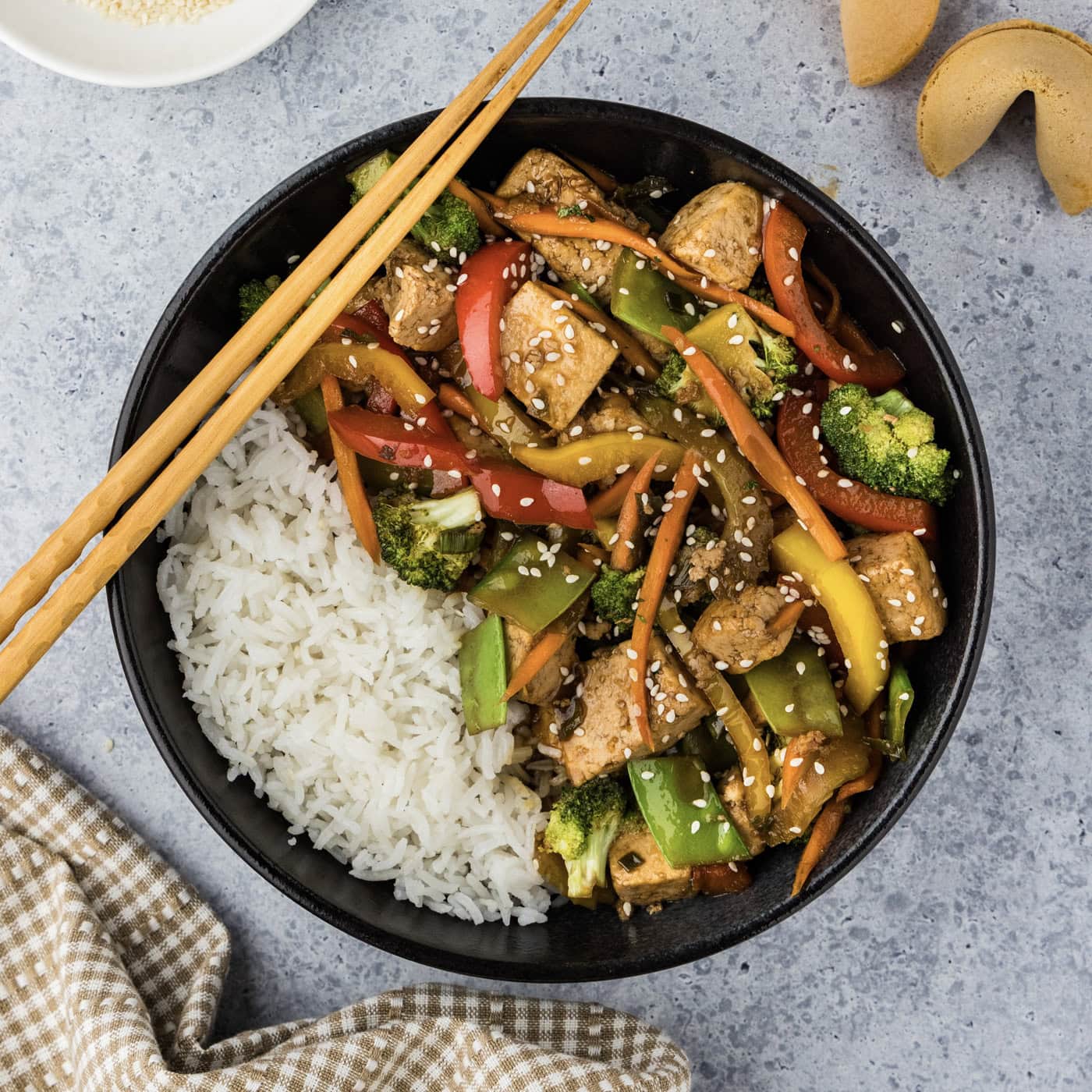 Bowl of Tofu Stir Fry with chopsticks on the side
