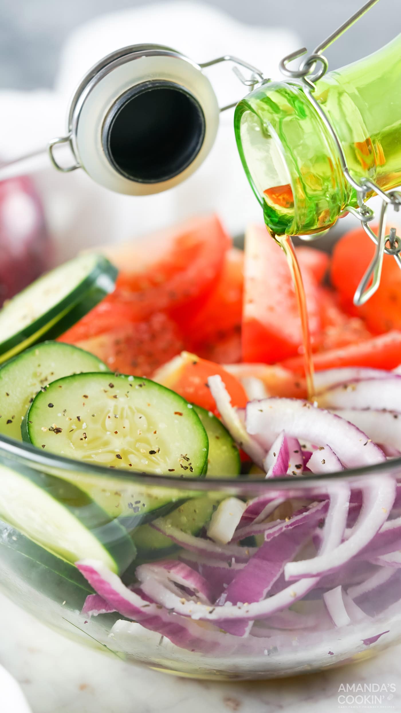 pouring olive oil on salad