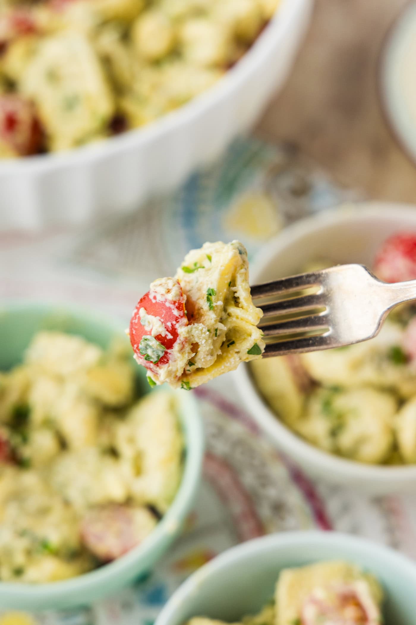 fork of creamy Tortellini Pesto Pasta Salad