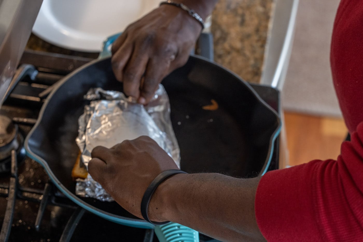 flipping foil of tuna salad over bread in a skillet
