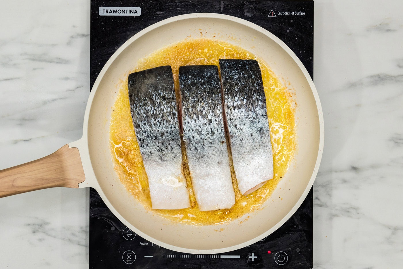 salmon filets in a skillet skin side up