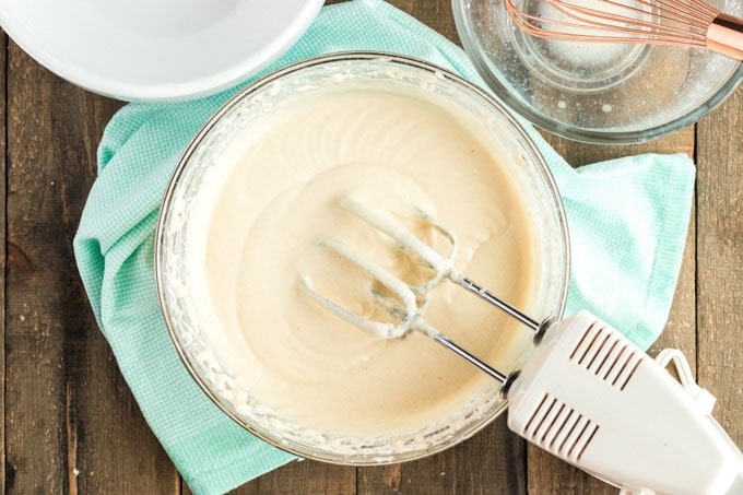 white cake batter in a bowl with a mixer