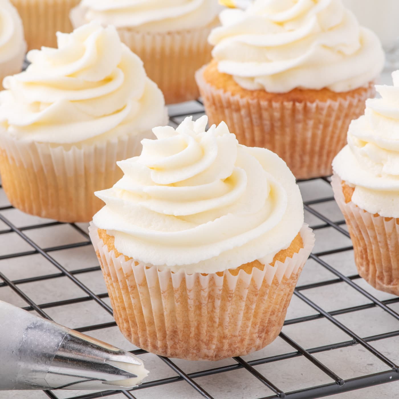 Close up photo of Vanilla Cupcakes on a wire rack
