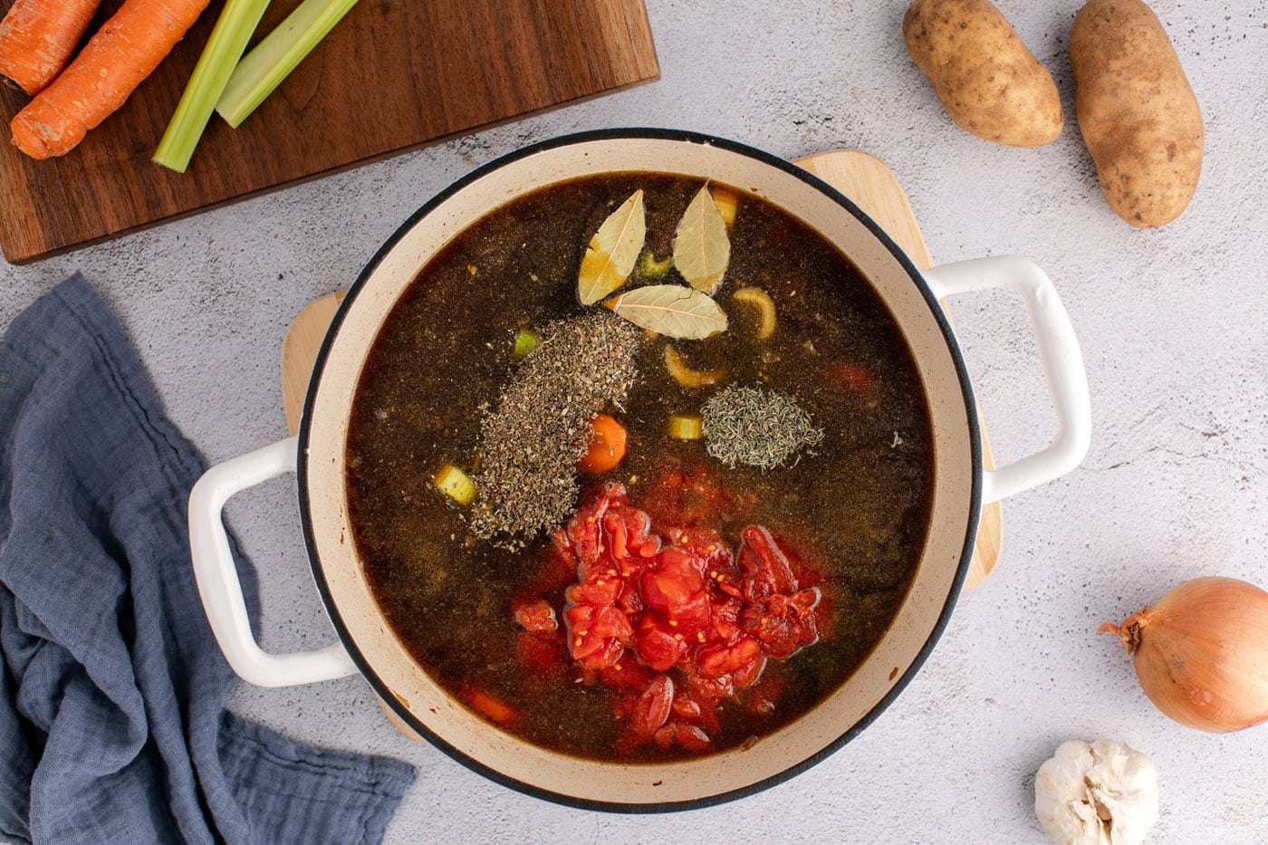 seasonings, beef broth, and diced tomatoes added to vegetable beef soup