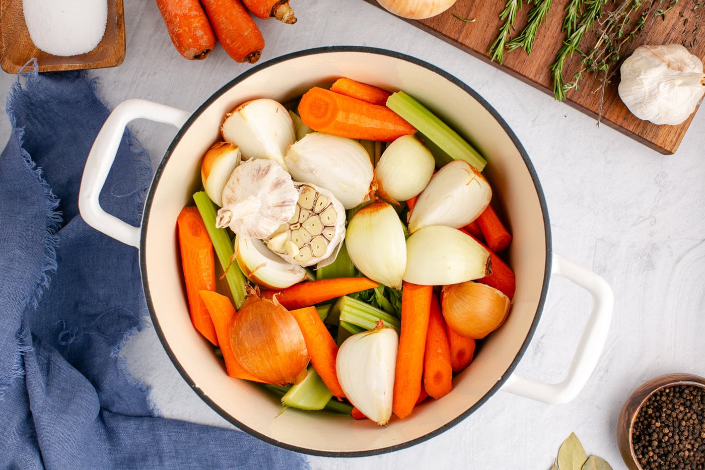 carrots, celery, onion, and garlic bulbs in a stockpot