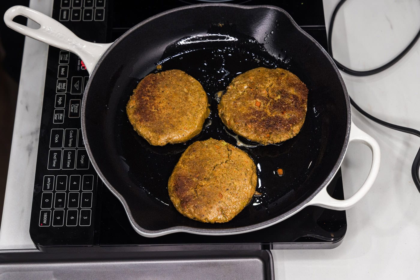 cooking veggie burger patties in a skillet