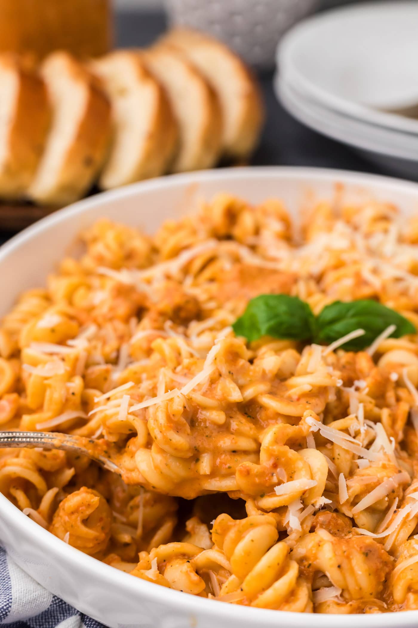 Close up photo of a spoon lifting out of a bowl of pasta covered in Vodka Sauce