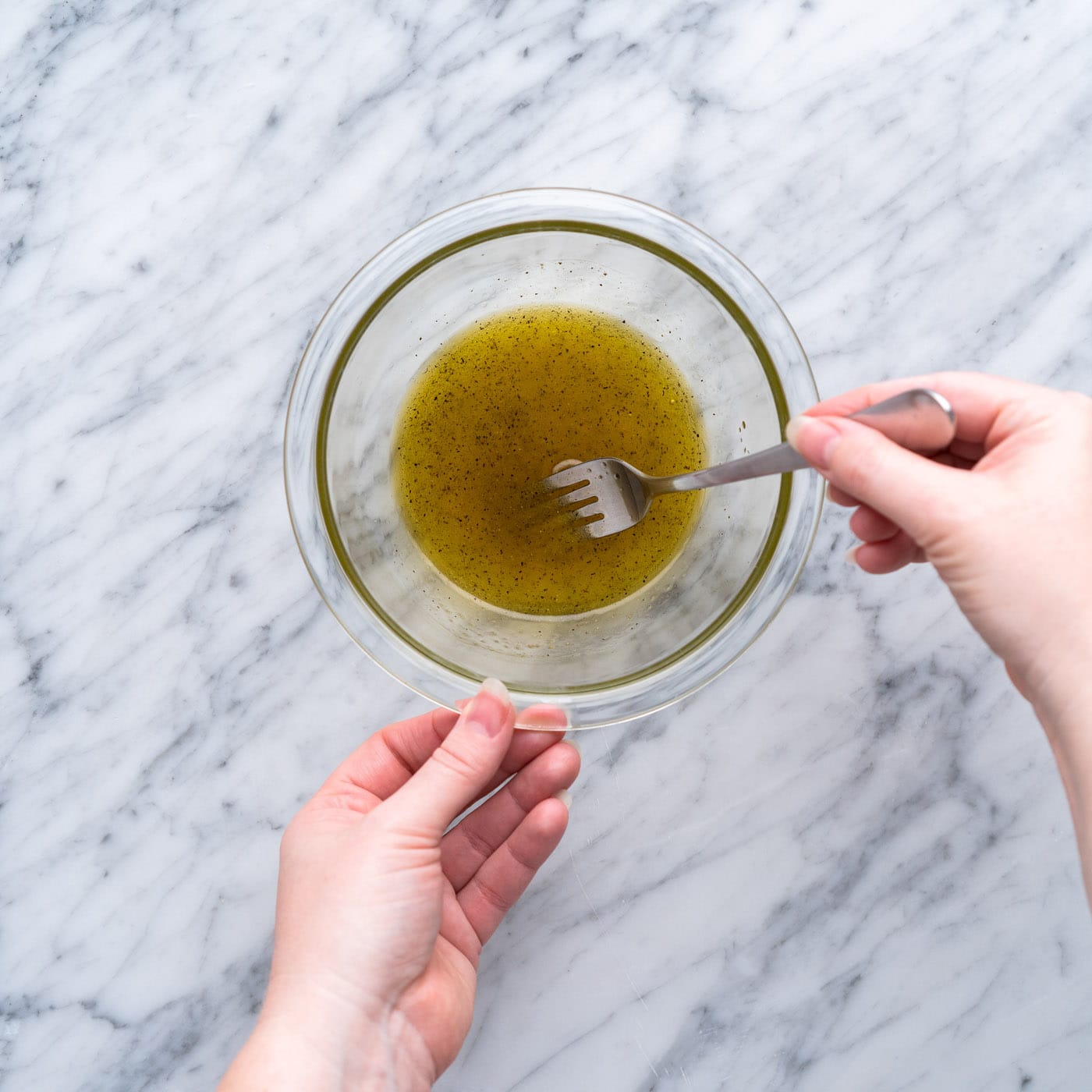 whisking vinaigrette in a small bowl