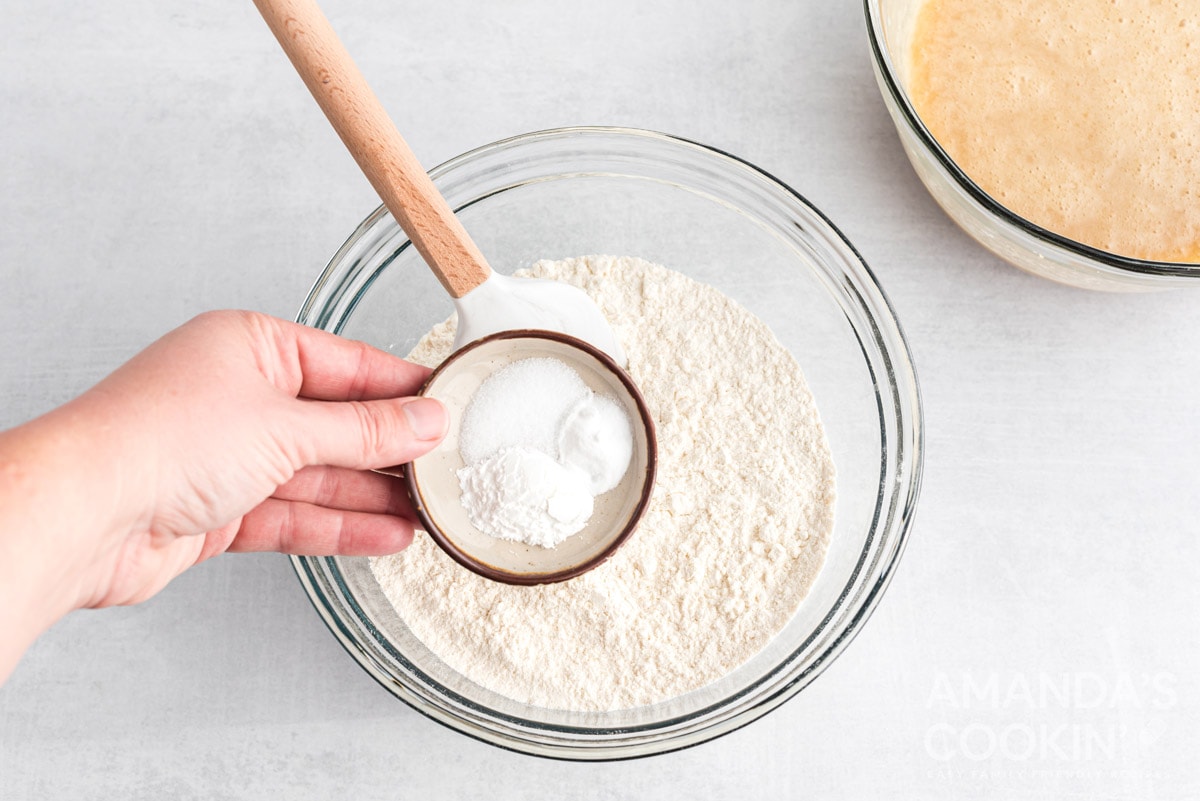 adding baking powder to bowl
