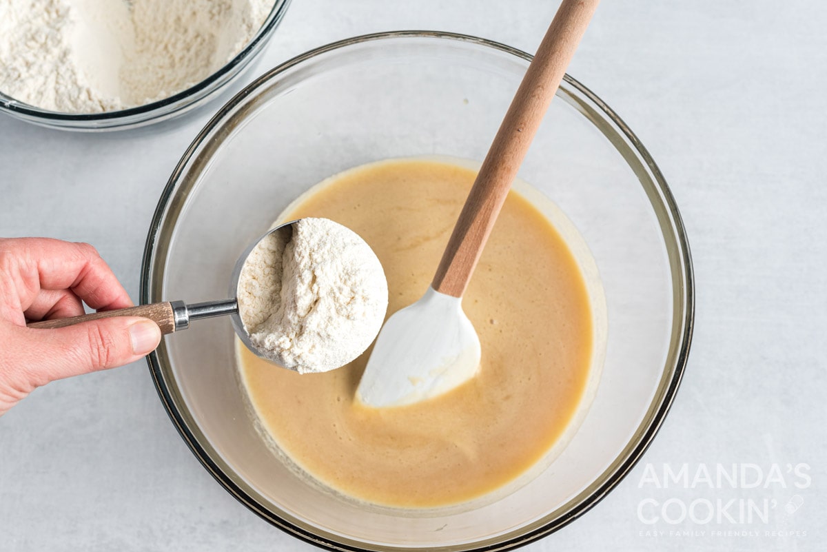 adding flour to cookie dough
