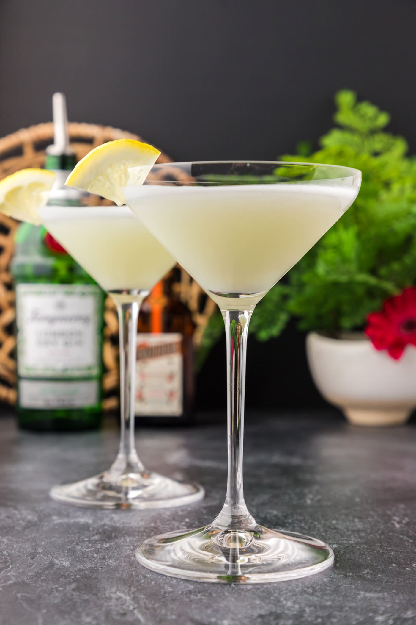 Two White Lady Cocktails garnished with a lemon wedge