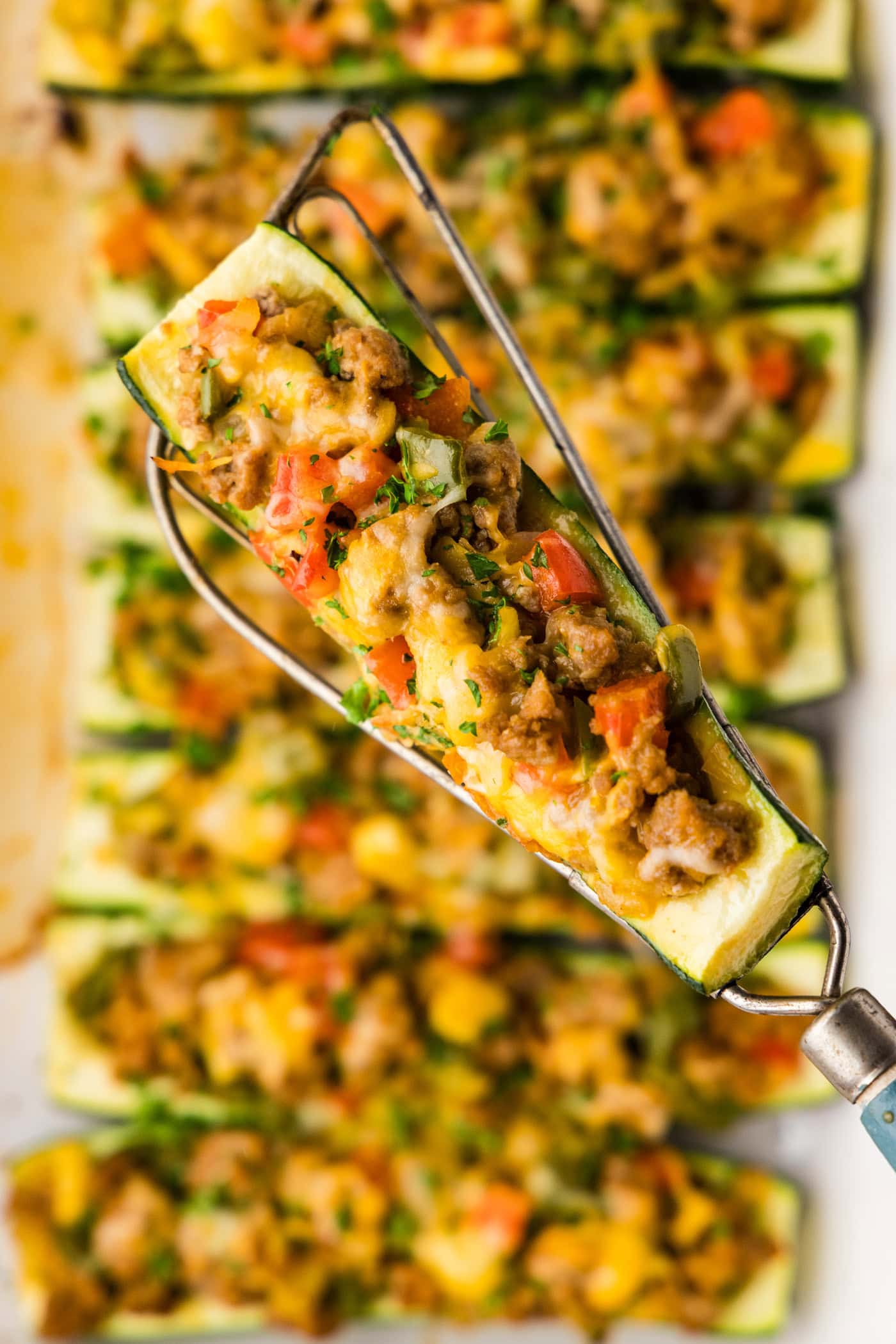 spatula lifting a Stuffed zucchini boats
