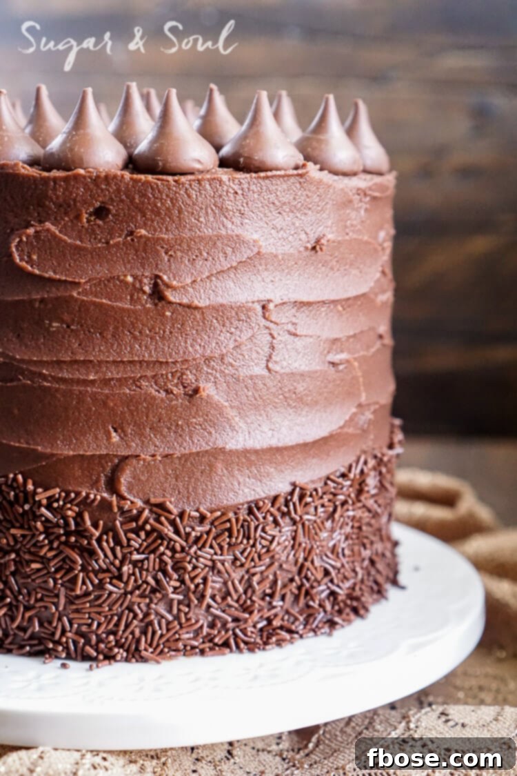 Close-up shot of a slice of Chocolate Pumpkin Cake revealing moist pumpkin layers and decadent chocolate frosting.