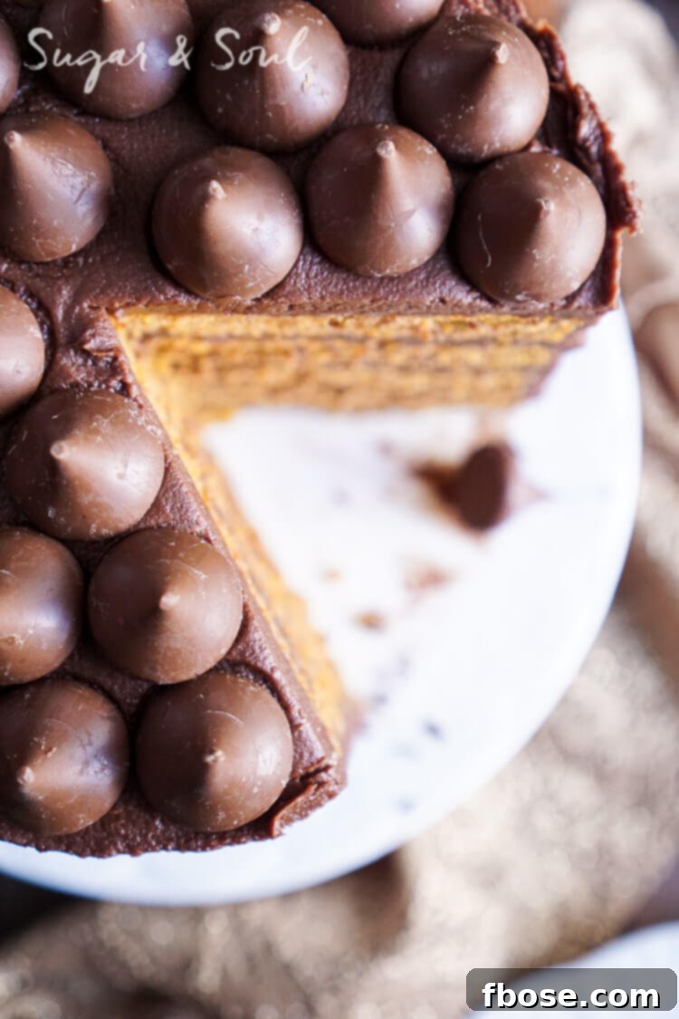 A stunning side view of the five-layer Chocolate Pumpkin Cake, showcasing its height and elegant decoration.