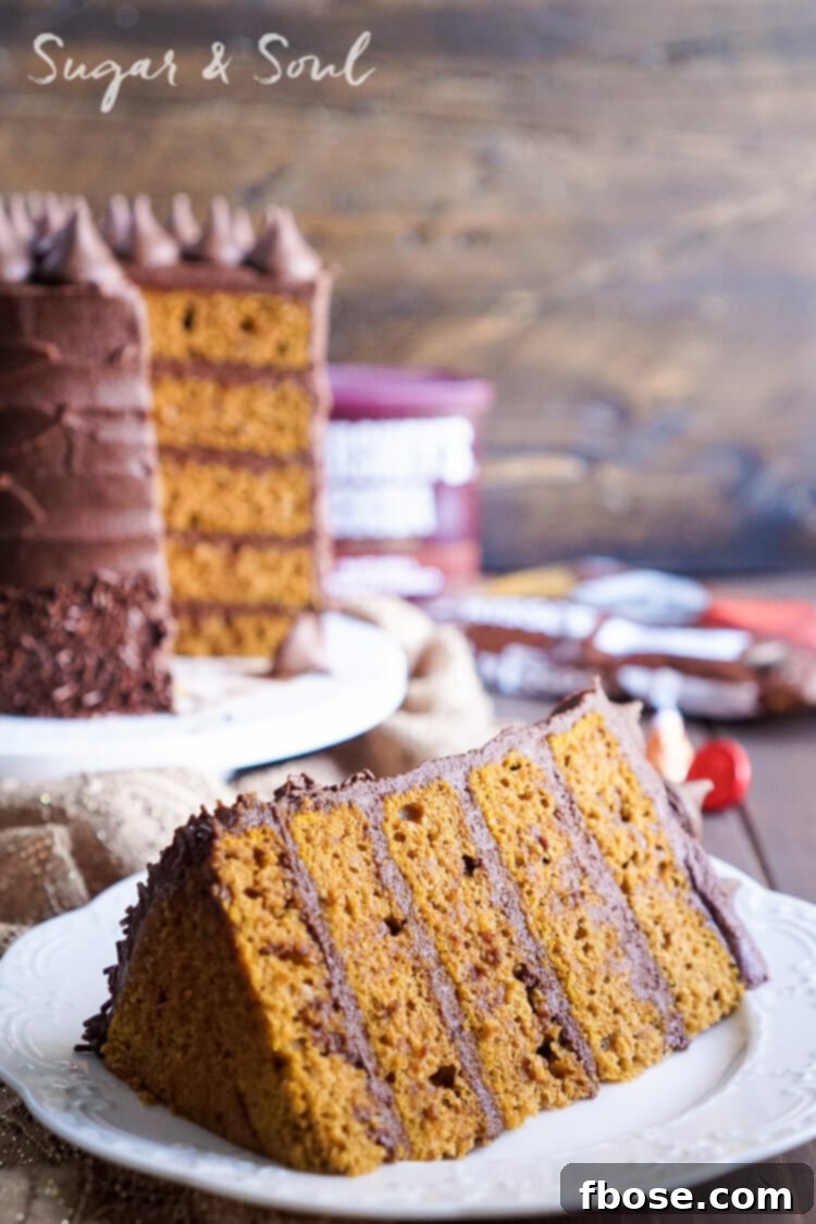 A tempting slice of Chocolate Pumpkin Cake on a plate, showing its moist texture and perfect frosting layers.