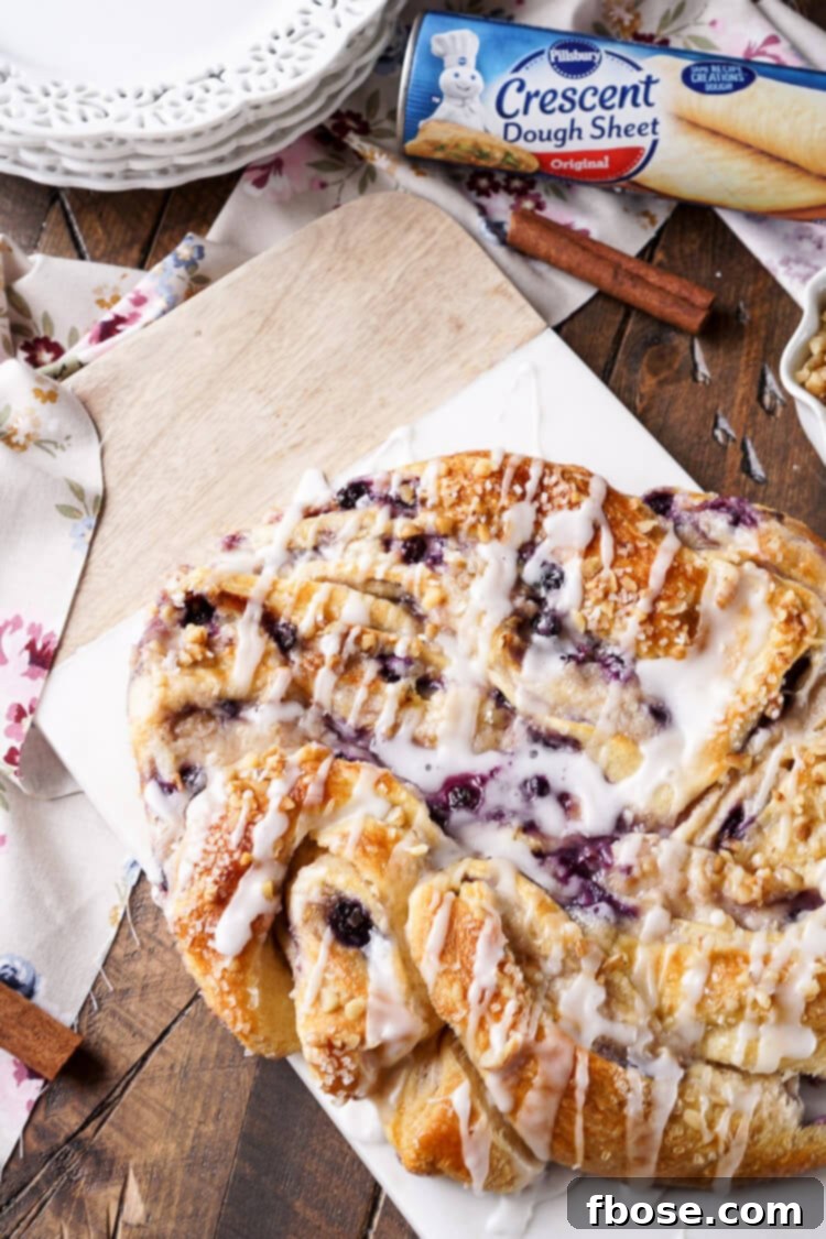 Spiced Blueberry Cream Cheese Twirl 2 This Blueberry Spice Cream Cheese Breakfast Ring is the perfect addition to a holiday brunch. A simple and sweet filling is wrapped up in crescent dough and topped with chopped pecans and icing for a delicious morning pastry the whole family can enjoy!