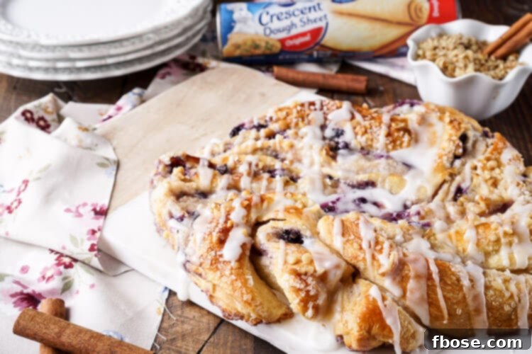 Spiced Blueberry Cream Cheese Twirl 4 This Blueberry Spice Cream Cheese Breakfast Ring is the perfect addition to a holiday brunch. A simple and sweet filling is wrapped up in crescent dough and topped with chopped pecans and icing for a delicious morning pastry the whole family can enjoy!